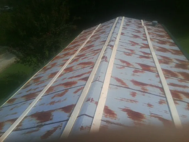 Rusted metal roof panels with new wood purlins before replacement — Storm Damage Roof Repair in Lebanon by Roofing Brothers